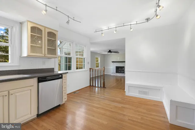 a kitchen with granite countertop a refrigerator and a stove top oven