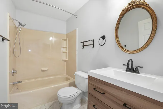 a view of a house with a big yard and large trees