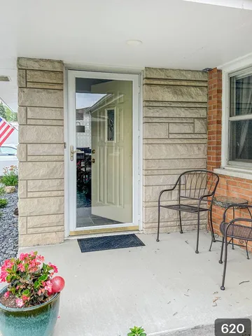 a front view of a house with outdoor seating