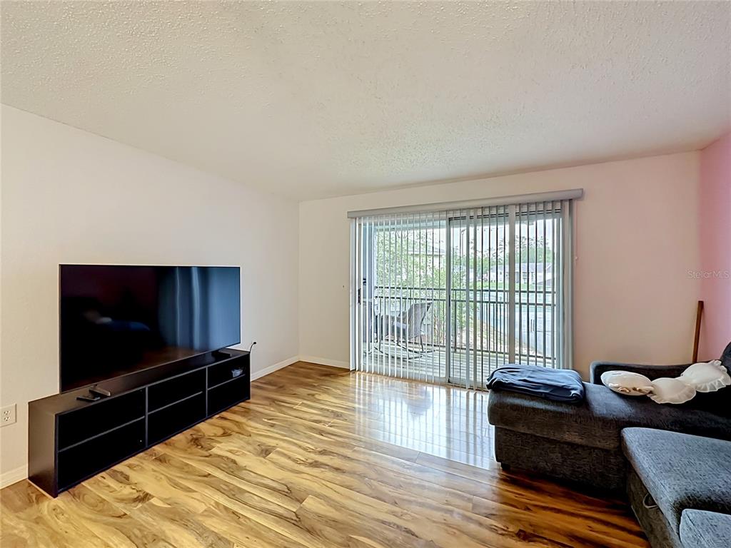 3705 Southwest 27th Street, Unit 922 Gainesville, FL 32608 - Photo 12 of 34 a living room with furniture and a flat screen tv