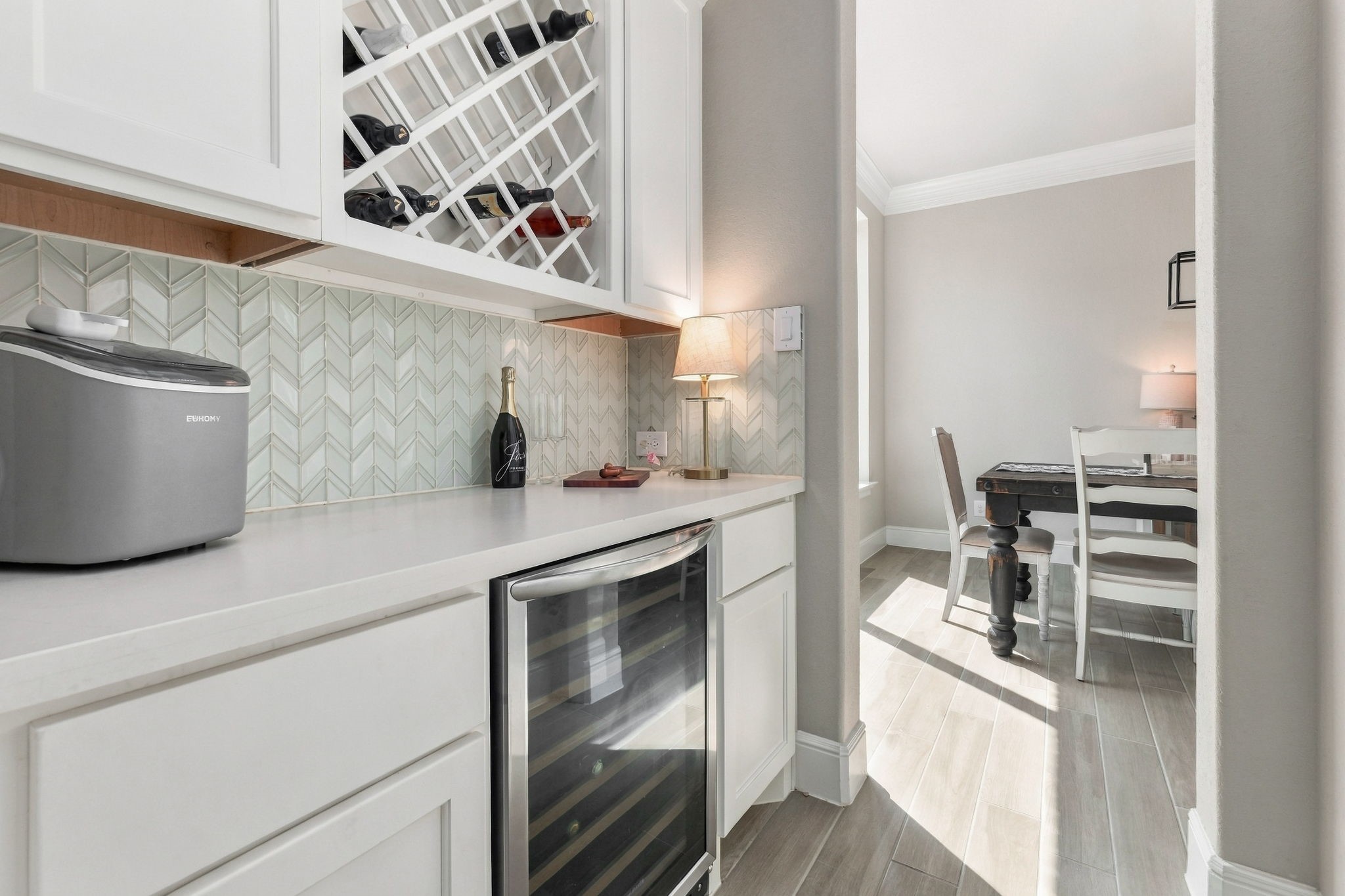 26910 Selinsgrove Road Magnolia, TX 77354 - Photo 12 of 47 A dedicated beverage nook adds an unexpected extra just off the main living areas.
Built-in cabinetry provides storage while the countertop creates a convenient serving station.