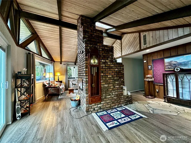 a kitchen with stainless steel appliances kitchen island granite countertop dining table chairs and a refrigerator
