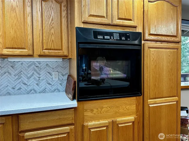 a kitchen with stainless steel appliances granite countertop a sink wooden cabinets and counter space