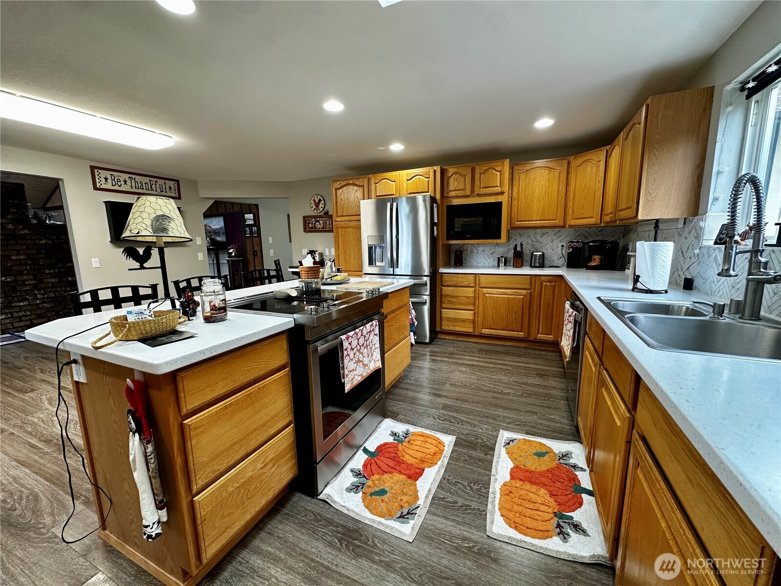 364 Old Dads Road Sequim, WA 98382 - Photo 20 of 37 a kitchen with stainless steel appliances granite countertop a sink wooden cabinets and counter space