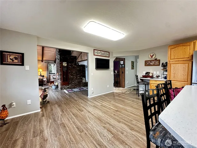 a bedroom with a bed and dresser with mirror