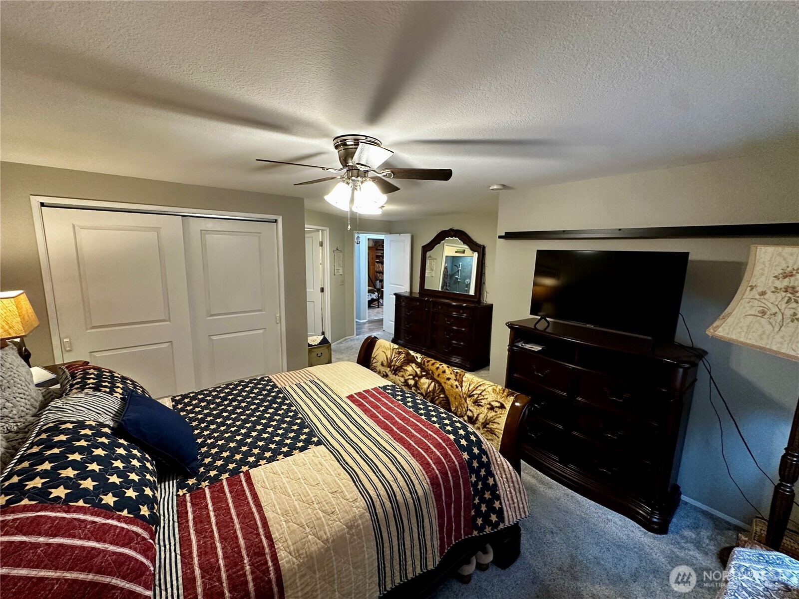 364 Old Dads Road Sequim, WA 98382 - Photo 24 of 37 a bedroom with a bed and dresser with mirror