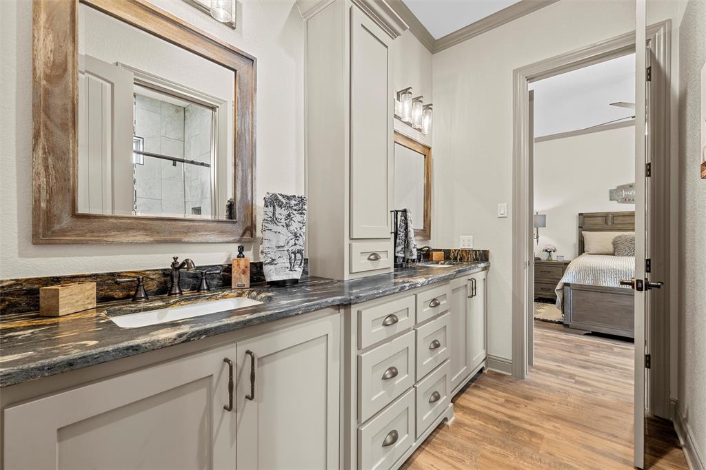 18503 Wortham Bend Road China Spring, TX 76633 - Photo 16 of 40 a spacious bathroom with double vanity and a mirror