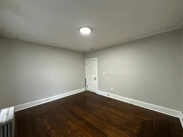 a view of room with wooden floor