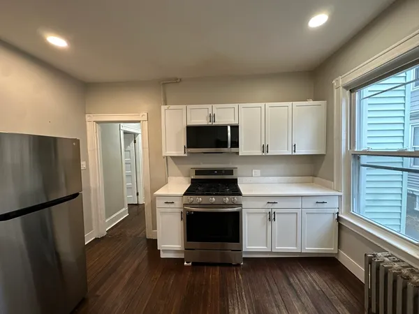 a kitchen with a stove a refrigerator and a sink