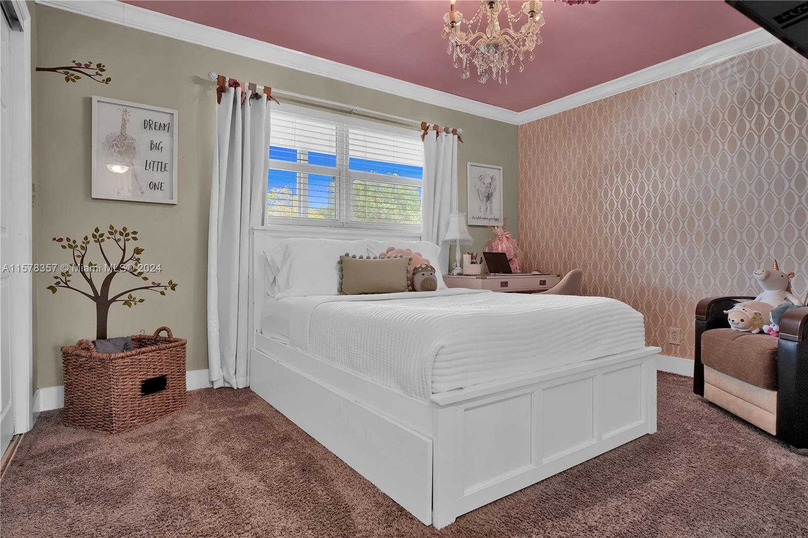 950 Hillcrest Drive, Unit 114 Hollywood, FL 33021 - Photo 11 of 24 a bedroom with a bed and a chandelier