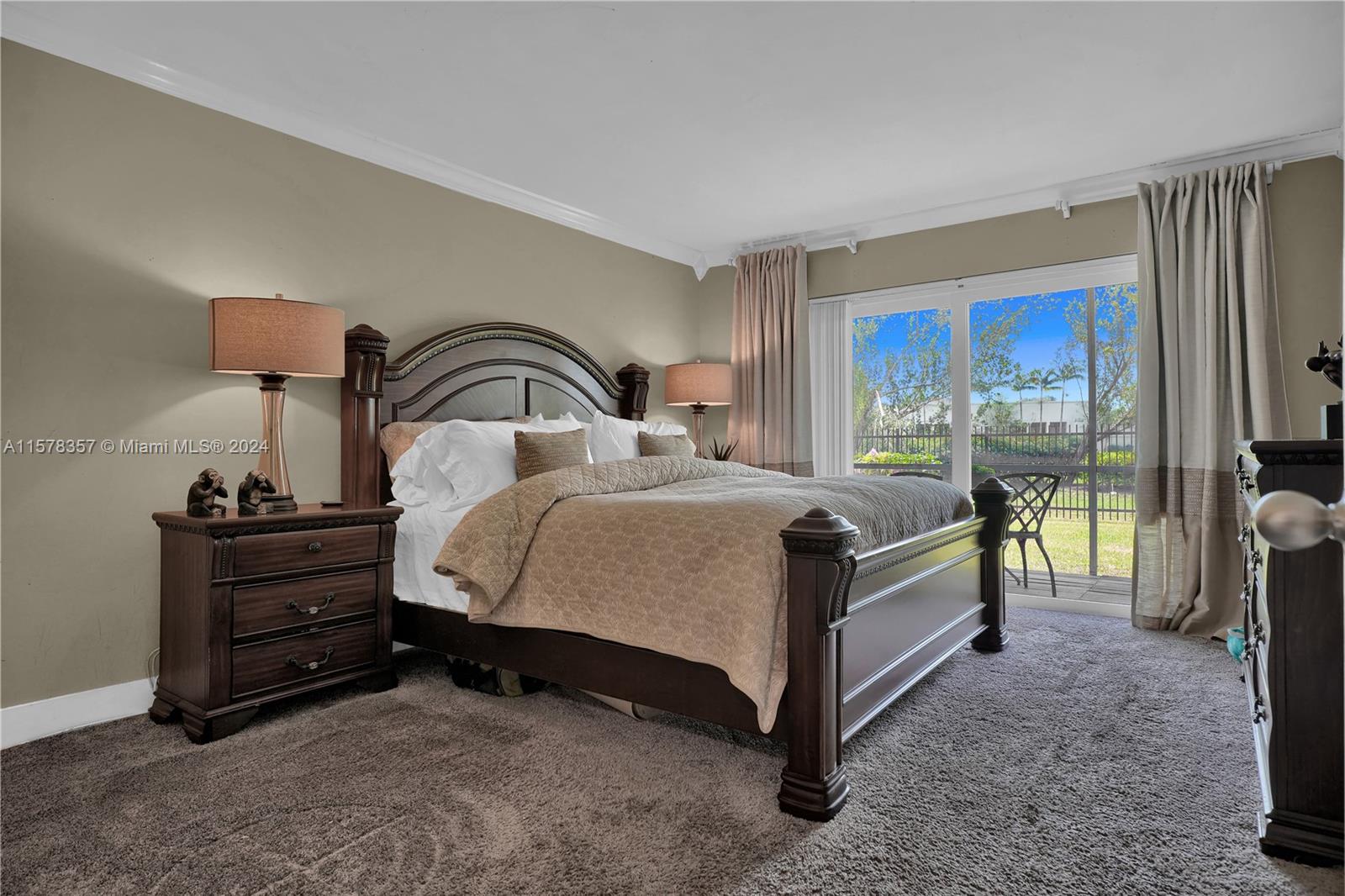 950 Hillcrest Drive, Unit 114 Hollywood, FL 33021 - Photo 15 of 24 a bedroom with a bed and a lamp on table