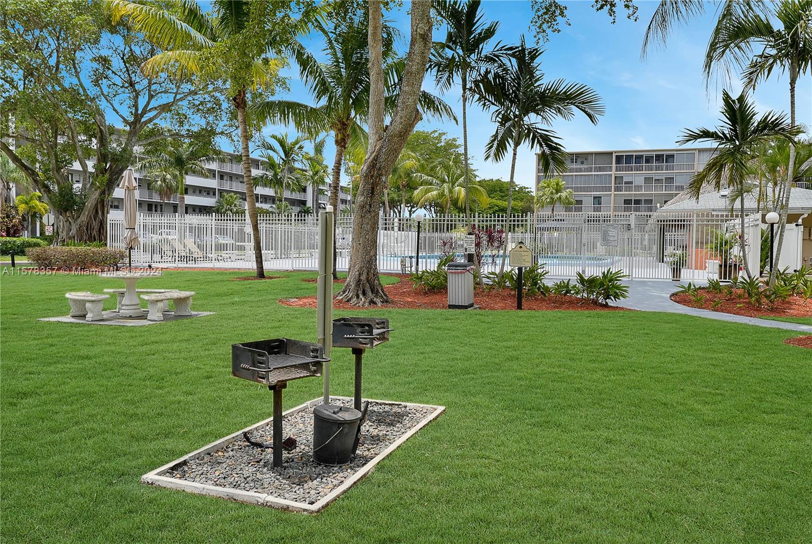 950 Hillcrest Drive, Unit 114 Hollywood, FL 33021 - Photo 22 of 24 a front view of a house with garden and trees