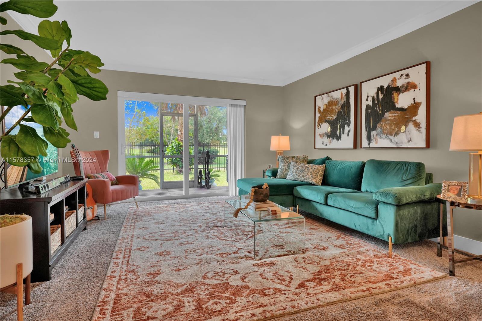 950 Hillcrest Drive, Unit 114 Hollywood, FL 33021 - Photo 4 of 24 a living room with furniture and a potted plant