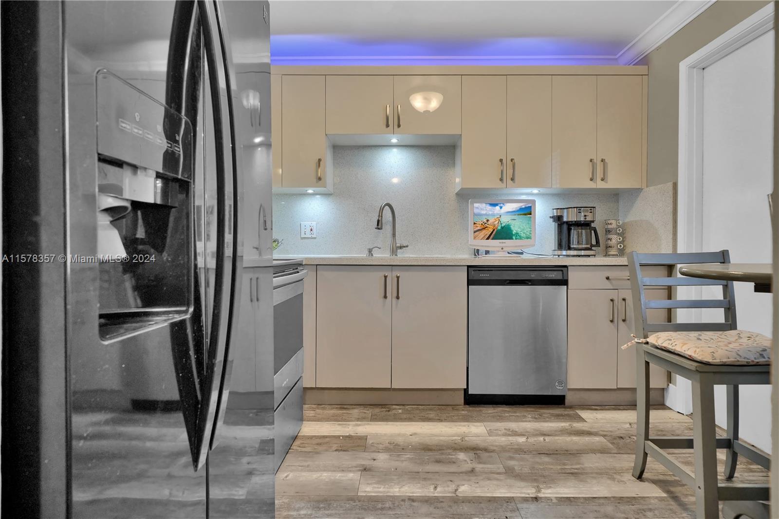 950 Hillcrest Drive, Unit 114 Hollywood, FL 33021 - Photo 6 of 24 a kitchen with stainless steel appliances granite countertop a refrigerator a stove and a sink