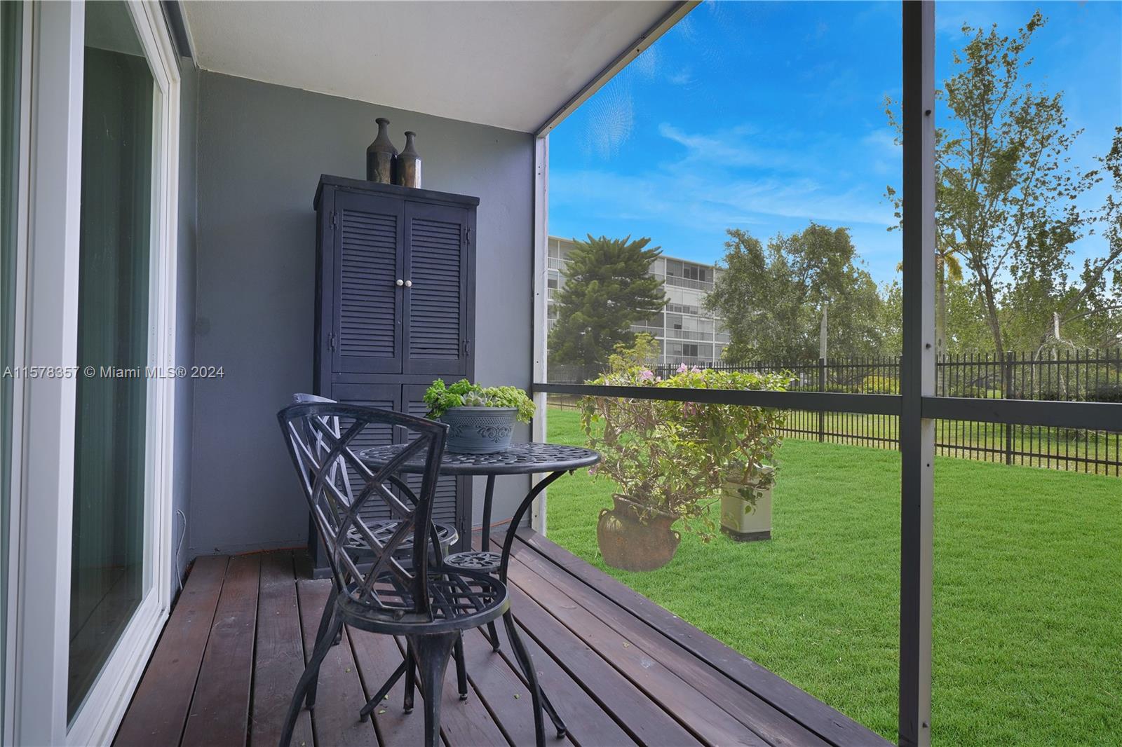 950 Hillcrest Drive, Unit 114 Hollywood, FL 33021 - Photo 9 of 24 a view of a chairs and table on the deck