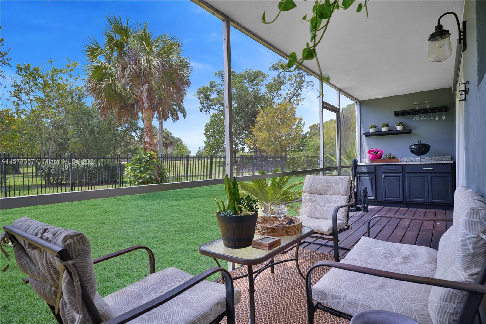 950 Hillcrest Drive, Unit 114 Hollywood, FL 33021 - Photo 10 of 24 a view of a patio with couches chairs and a yard