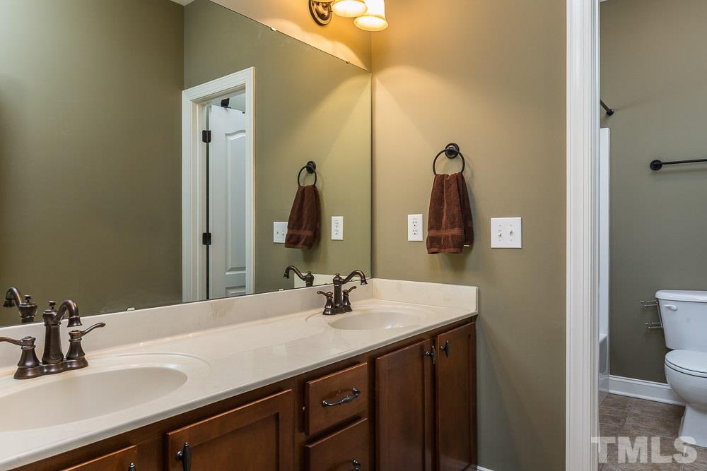 654 Democracy Street Raleigh, NC 27603 - Photo 14 of 24 a bathroom with a sink and a mirror