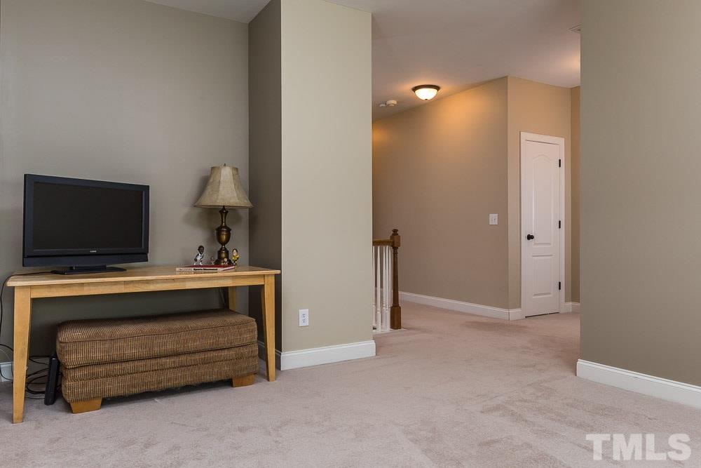 654 Democracy Street Raleigh, NC 27603 - Photo 20 of 24 a view of room with flat screen tv and a lamp