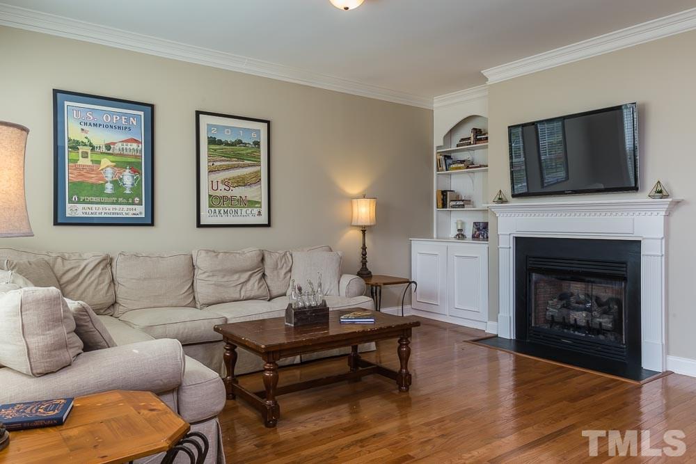 654 Democracy Street Raleigh, NC 27603 - Photo 4 of 24 a living room with furniture and a fireplace