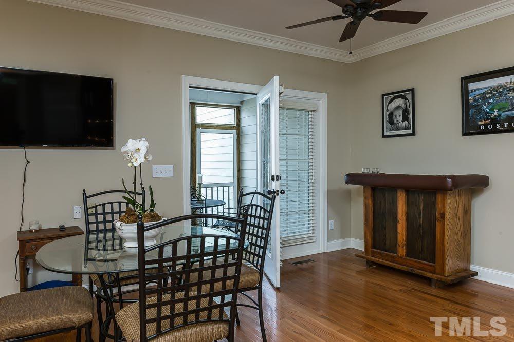 654 Democracy Street Raleigh, NC 27603 - Photo 9 of 24 a bedroom with furniture window and wooden floor