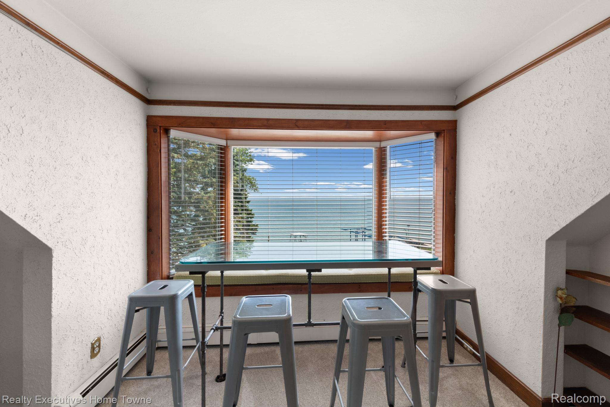 8308 Lakeshore Road Fort Gratiot, MI 48059 - Photo 69 of 79 Bay window with water scenery and wood trim, featuring a built-in window seat
