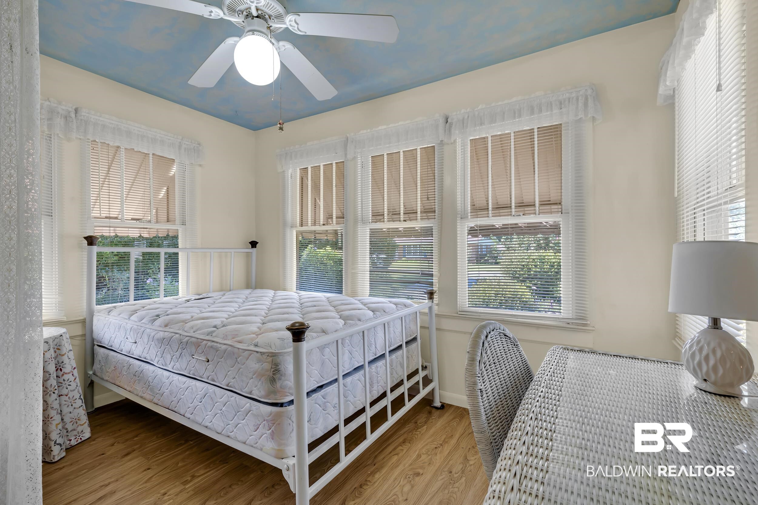 304 West Myrtle Avenue Foley, AL 36535 - Photo 11 of 29 Room with wood-finish flooring, a ceiling fan with integrated lighting, and a painted ceiling