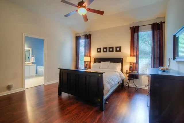 a bedroom with a bed and wooden floor