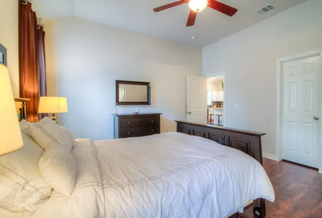 a bedroom with a bed and a chandelier