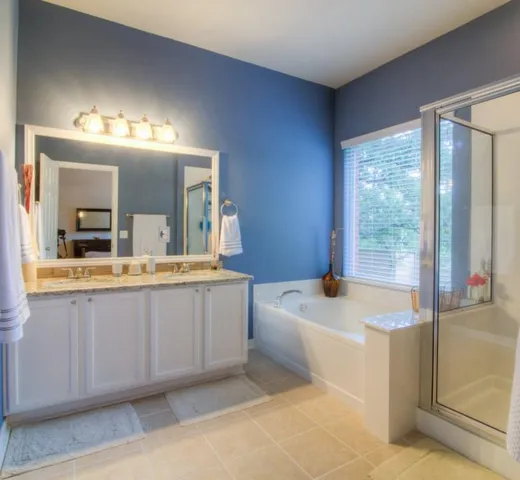 a bathroom with a sink a bathtub a mirror and vanity