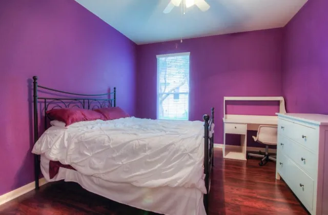 a bed room with a bed and a dresser