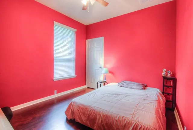 a bedroom with a bed and a window