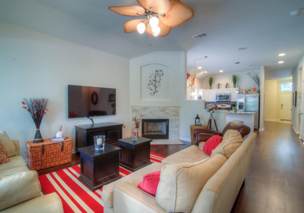 3454 Shiraz Loop Round Rock, TX 78665 - Photo 8 of 23 a living room with furniture fireplace and a flat screen tv