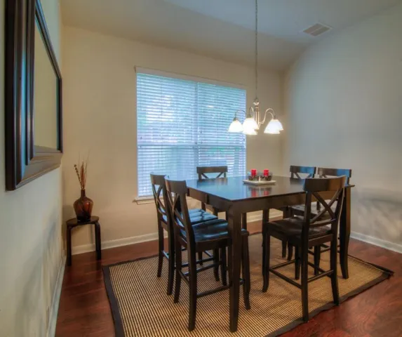 a view of a dining room with furniture and chandelier