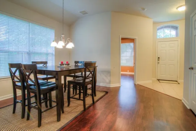a view of a dining room with furniture and wooden floor