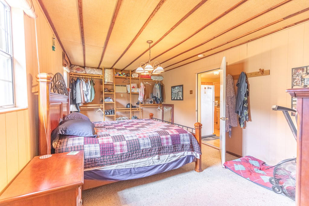 447-495 Blessing Lane Utopia, TX 78884 - Photo 11 of 24 a bedroom with bed and wooden floor