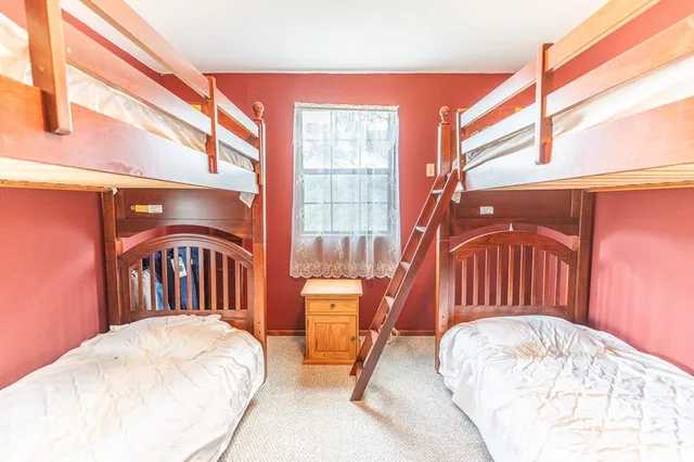 a view of a bedroom with a bed and glass door