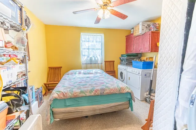 a bedroom with a bed table and chair