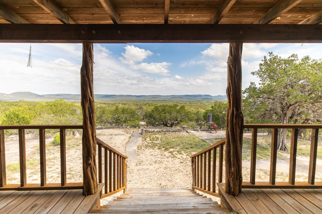 447-495 Blessing Lane Utopia, TX 78884 - Photo 2 of 24 a view of a wooden balcony with a yard