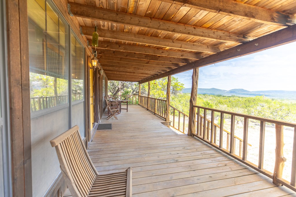 447-495 Blessing Lane Utopia, TX 78884 - Photo 3 of 24 a view of a balcony with wooden floor