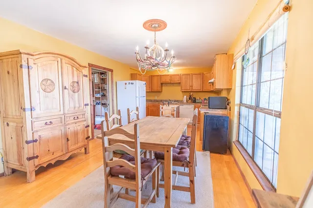 a dining room with furniture and a chandelier