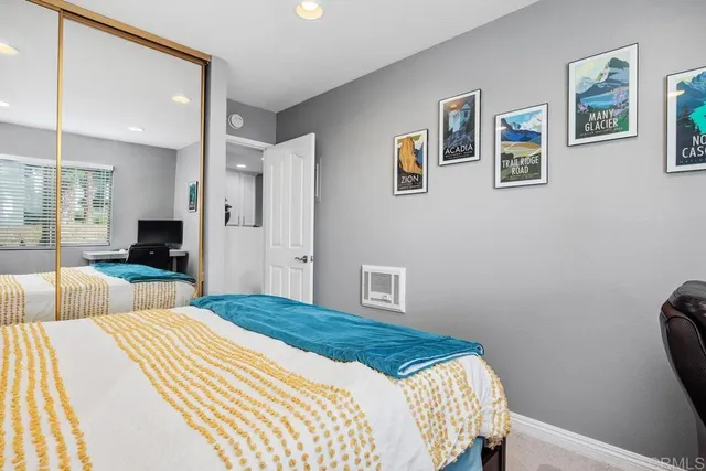 a bedroom with a bed a dresser and potted plants