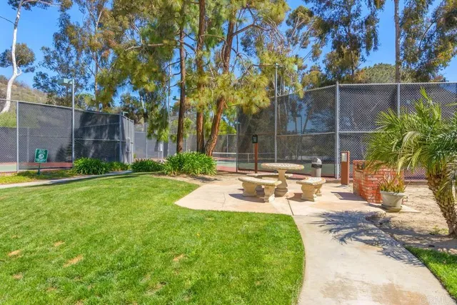 a view of a white house with a large window potted plants and floor to ceiling window