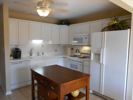21143 Deerpath Road Frankfort, IL 60423 - Photo 7 of 16 a kitchen with stainless steel appliances a stove refrigerator sink and cabinets