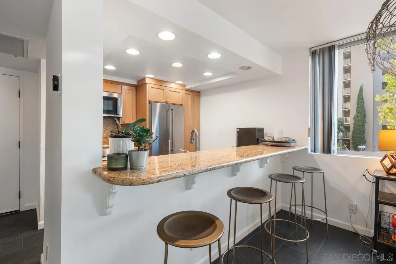 3635 7th Avenue, Unit 2D San Diego, CA 92103 - Photo 11 of 68 a kitchen with stainless steel appliances granite countertop a sink and a refrigerator