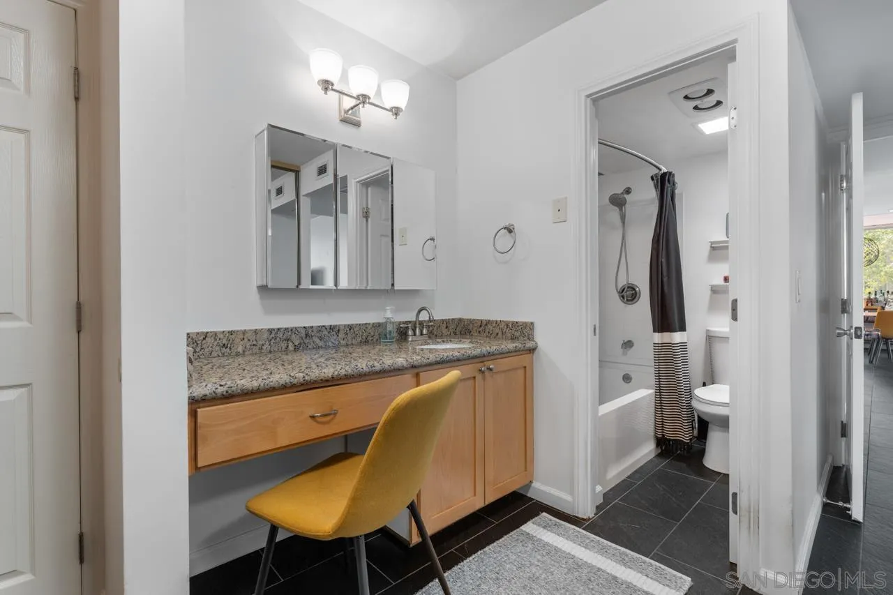 3635 7th Avenue, Unit 2D San Diego, CA 92103 - Photo 33 of 68 a bathroom with a granite countertop sink and a mirror