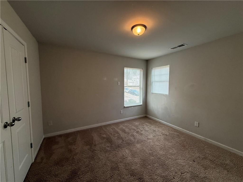 4299 Traipse Path Ellenwood, GA 30294 - Photo 11 of 12 an empty room with windows and closet