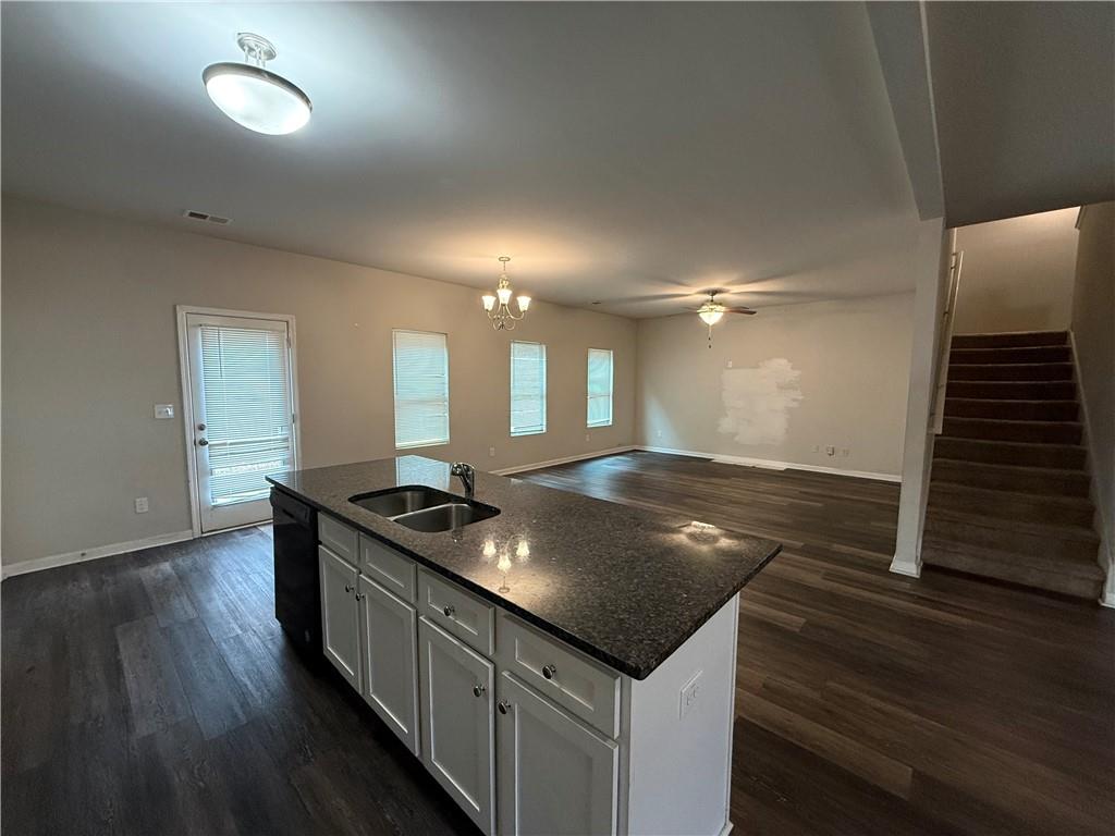 4299 Traipse Path Ellenwood, GA 30294 - Photo 3 of 12 a kitchen with stainless steel appliances granite countertop a sink and wooden floor