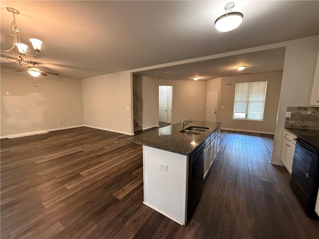 4299 Traipse Path Ellenwood, GA 30294 - Photo 5 of 12 a kitchen with stainless steel appliances granite countertop a stove and a wooden floors