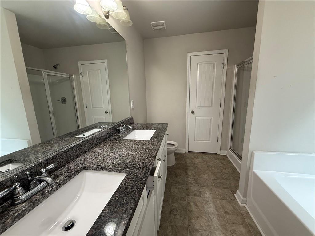 4299 Traipse Path Ellenwood, GA 30294 - Photo 8 of 12 a bathroom with a granite countertop sink a mirror and a bathtub
