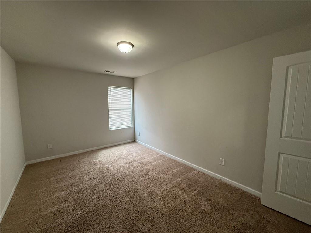 4299 Traipse Path Ellenwood, GA 30294 - Photo 9 of 12 an empty room with windows and closet